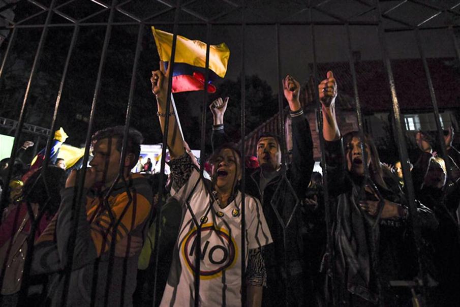 People protest after knowing the results of a referendum on whether to ratify a historic peace accord to end a 52-year war between the state and the communist FARC rebels, in Bogota on October 2, 2016.<br /><br /><br /><br /><br /><br /><br /><br /><br />
Colombian voters rejected a peace deal with communist FARC rebels Sunday, near-complete referendum results indicated, blasting away what the government hoped would be a historic end to a 52-year conflict. / AFP PHOTO / LUIS ACOSTA